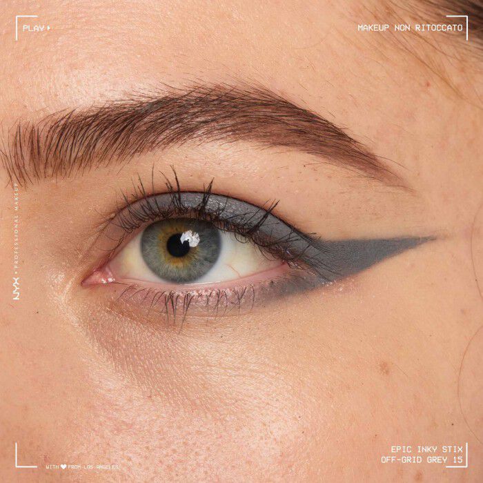Close of a model wearing Epic Inky Stix on the top of their eyelid as a winged liner style in shade 15 Off-Grid Grey