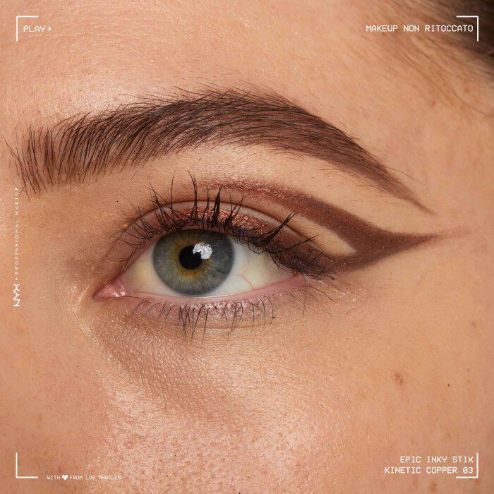 Close of a model wearing Epic Inky Stix on the top of their eyelid as a winged liner style in shade 03 Kinetic Copper