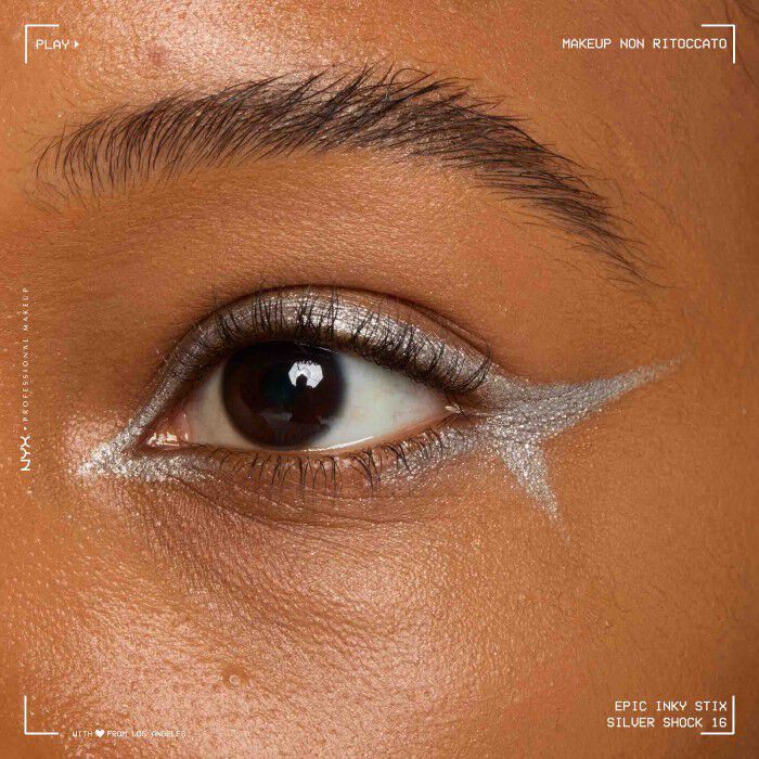 Close of a model wearing Epic Inky Stix on the top of their eyelid as a winged liner style in shade 16 Silver Shock