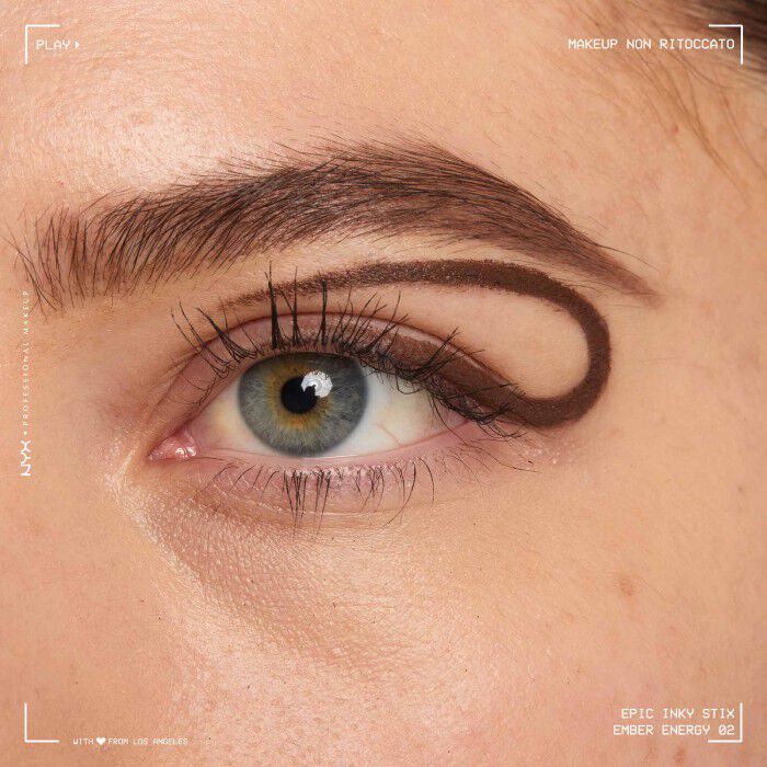Close of a model wearing Epic Inky Stix on the top of their eyelid as a winged liner style in shade 02 Ember Energy