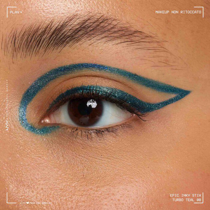 Close of a model wearing Epic Inky Stix on the top of their eyelid as a winged liner style in shade 07 Turbo Teal