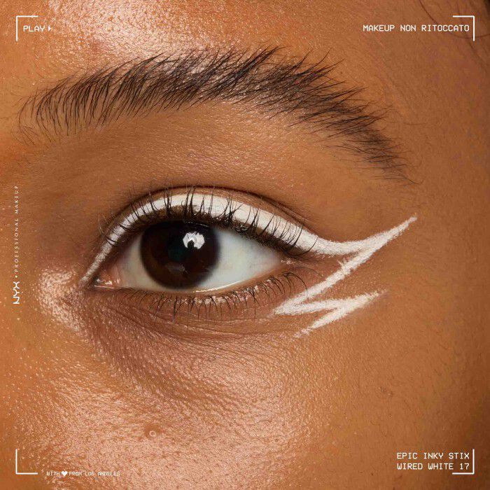 Close of a model wearing Epic Inky Stix on the top of their eyelid as a winged liner style in shade 17 Wired White
